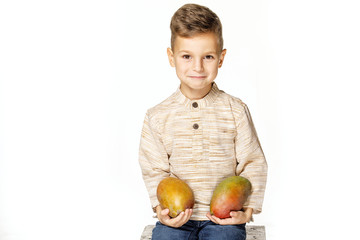 Fototapeta premium handsome pretty boy is holding a mango 