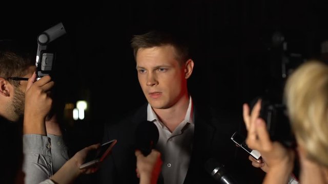 Serious pr manager giving interview to newspaper journalist instead celebrity