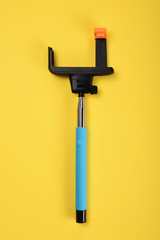 Selfie stick on yellow background