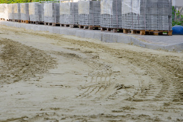 road works on laying paving slabs with laying of sand