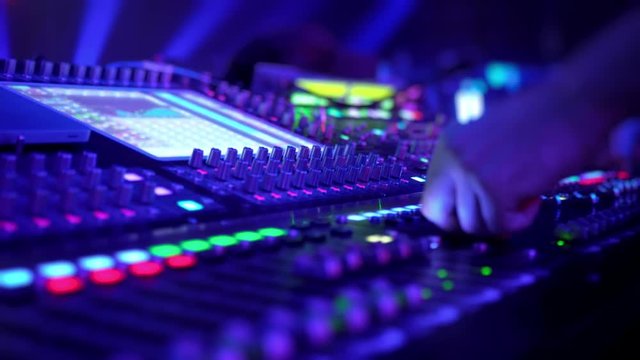 Remote control for adjusting the sound. Audio mixer. Sound engineer adjusts the sound. Music Festival. Change the volume level. Recording studio. Shooting a television show, a concert. Live broadcast.