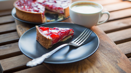 Still life with a Cup of coffee and sweet dessert with strawberries, cheesecake cake