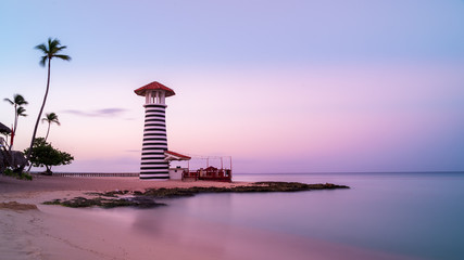 Sunrise at Bayahibe beach with smooth water, La Romana, Dominican republic - obrazy, fototapety, plakaty