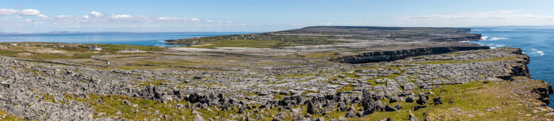 Fototapeta na wymiar Panorama with Cliffs, Farms, rocks and vegetation in Inishmore with ocean in background