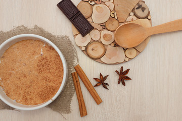 Milk buckwheat soup sprinkled with cinnamon and star anise on the table.