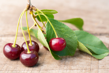 Ripe red cherries on old boards