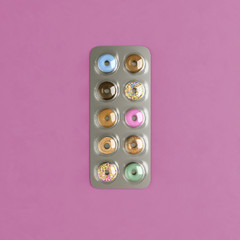 Blister pills diet concept food packed inside. Food concept medicines idea on pink background.