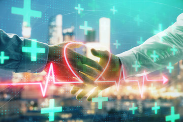 Double exposure of heart drawing on city view background with handshake. Concept of medical education