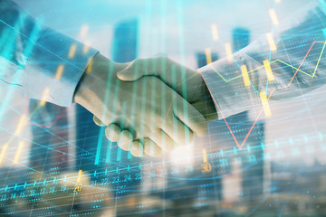 Double exposure of financial graph on cityscape background with two businessman handshake. Concept of stock market deal