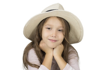 A little girl in a hat. The child's face close-up.