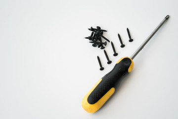 Black screws of self-tapping screws of same sizes isolated on white background.