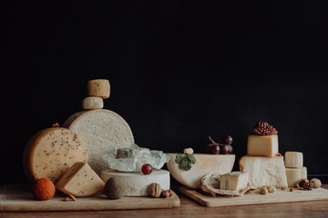 various types of cheese on rustic wooden table