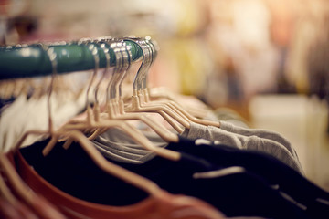 Clothes on hangers in shop for sale