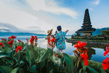 Couple spending time at the ulun datu bratan temple in Bali. Concept about exotic lifestyle...