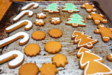 Handmade decorating of festive gingerbread cookies in the form of stars, snowflakes, people, socks, staff, mittens, Christmas trees, hearts for xmas and new year holiday. preparation for holidays