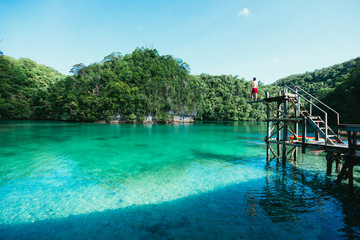 Man meditate at the lagoon in the morning, enjoying the view. Shot at the sugba bay in...