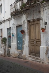 Old side of house with windows and door in Spain