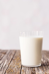 Glass of milk on rustic wooden table
