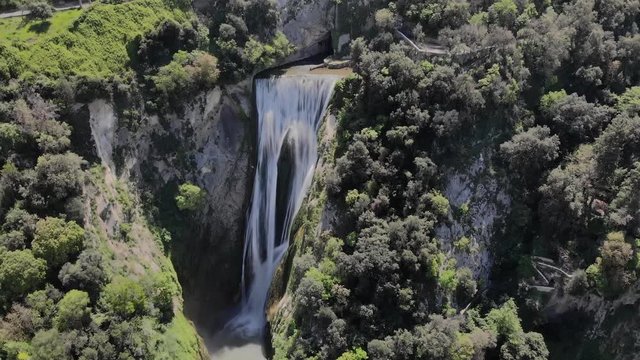 Aerial flight over the Waterfall that is in Tivoli Italy. Waterfall in the national Park in Sunny weather