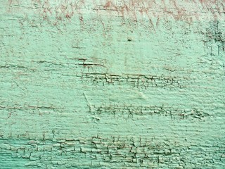 the background is covered with a layer of weathered turquoise paint