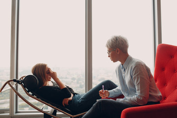 Consultation of young woman patient on reception for psychologist.