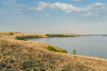 Eastern European steppe landscape with reservoir. End of summer. Landscape park, Donbass.