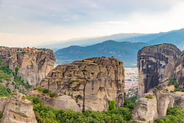 Fototapeta na wymiar Wonderful view of the rocks and monasteries of Meteora, Greece. Mysterious Sunny evening with colorful sky, during sunset. Awesome Nature Landscape. Amazing Greece. Popular travel locations
