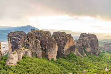 Wonderful view of the rocks and monasteries of Meteora, Greece. Mysterious Sunny evening with colorful sky, during sunset. Awesome Nature Landscape. Amazing Greece. Popular travel locations