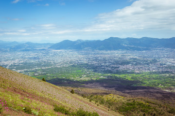 Fototapeta premium View from Vesuvius volcano in Italy to the coast of sea and city from above, against the sky.