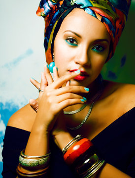 beauty bright african woman with creative make up, shawl on head like cubian closeup smiling