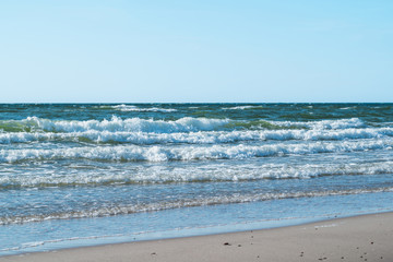 pure azure clear water with white foam on the sea on a sunny aft