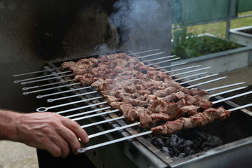 Roasted meat cooked at barbecue with smoke. Traditional eastern dish.