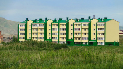 New apartment building. Ust-Kamenogorsk (Kazakhstan). Modern architecture. New residential area. Newly built. Green grass