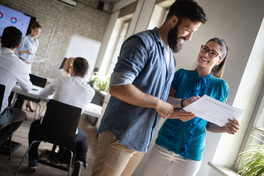 Successful happy group of people learning software engineering and business during presentation