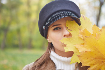 Beautiful gentle woman in the autumn park