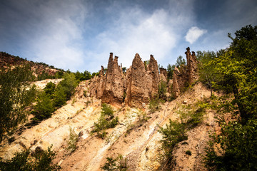 Fototapeta na wymiar Devil's town (Djavolja Varos), Sandstone structures with stones on top. Interesting rock formations made by strong erosion on Radan mountain in Serbia.