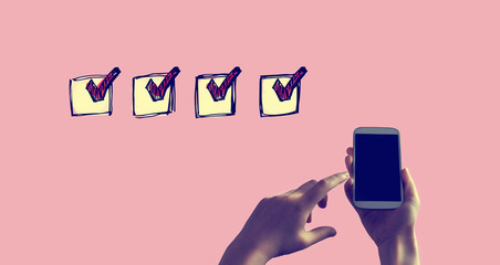 Checklist with person holding a white smartphone
