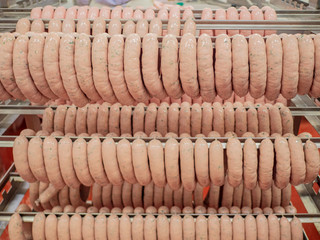 Raw Fresh sausages in the sausage shop. Meat workshop of specialized supermarket. Own production
