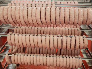 Raw Fresh sausages in the sausage shop. Meat workshop of specialized supermarket. Own production