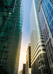 Modern city building architecture with glass fronts on a clear day in London, England