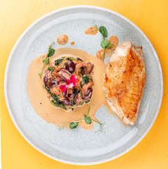 Fried chicken breast, with stewed spinach and grapes.