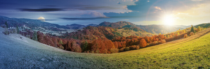 day and night time change concept above panoramic landscape in october. grassy meadow and trees in fall foliage. mountain range in the distance beneath a sun and moon on the sky