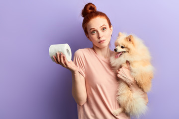 puzzled girl doesn't know how to teach her pet to clean after itself , toilet training.close up...