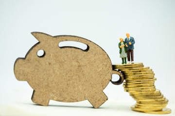 Miniature people: Happy old people standing on coins stack, Retirement planning, Emergency plan, Life insurance and Financial Concept.