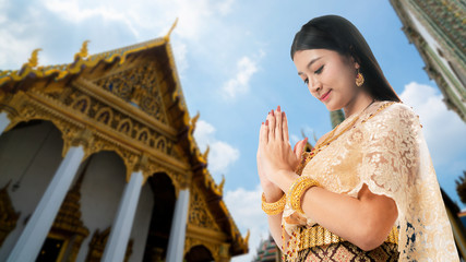 Beautiful Thai woman portrait dress up in traditional thai costume at Temple of the Emerald Buddha...