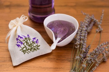 Fototapeta na wymiar the lavender jam on wooden background with pouch for kitchen service concept