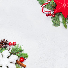 Christmas composition. Red stars, holly berries, snowflake and green fir branch on white background. Xmas flat lay top view with copy space