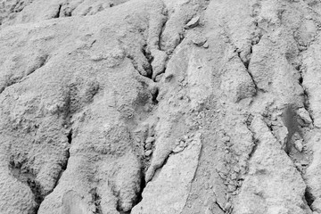 Abstract rough dry shape created by wind and water on abandoned kaolin quarry in black and white.