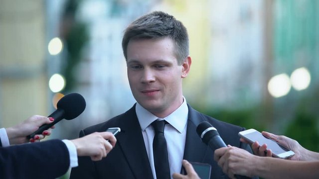 Successful businessman giving interview on journalist press conference, news