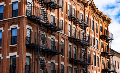 Red Fire escape stairs-downtown back alley architecture-steel and red brick background